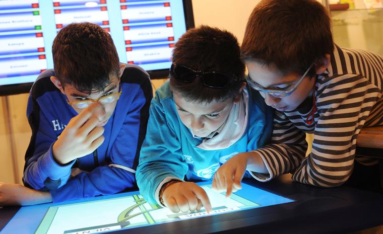 Unos ni&ntilde;os con discapacidad visual utilizan una pantalla interactiva