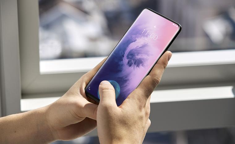 Imagen comercial del One Plus 7 Pro en la que una persona desbloquea el tel&eacute;fono con la huella digital