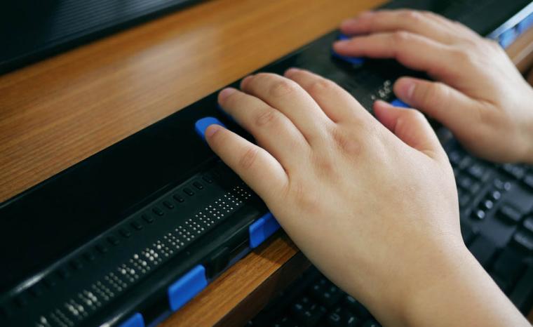Una personas utiliza una l&iacute;nea braille con su ordenador